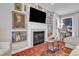Elegant living room features a fireplace with mantel and framed art, comfortable seating, and natural light at 2340 Florida Ct, Raleigh, NC 27615