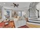 Open concept living room with hardwood floors, comfortable seating, and an adjacent staircase at 2340 Florida Ct, Raleigh, NC 27615