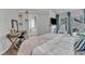 Sunlit primary bedroom with a desk area, TV over fireplace, and ensuite bathroom access at 2340 Florida Ct, Raleigh, NC 27615