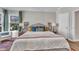 Bedroom with a large bed, window views, a sitting chair, and an adjacent ensuite bathroom at 2340 Florida Ct, Raleigh, NC 27615