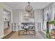 Bright home office with modern desk, white shelving, and view into kitchen at 2340 Florida Ct, Raleigh, NC 27615