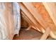 Partially finished attic space with exposed beams and insulation, offering potential for storage at 236 Summer Place Ct, Clayton, NC 27527
