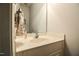 Powder room with a white vanity, sink, mirror and neutral wall color at 236 Summer Place Ct, Clayton, NC 27527
