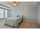Carpeted bedroom featuring a ceiling fan, tray ceiling and window at 236 Summer Place Ct, Clayton, NC 27527