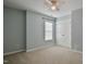 Neutral bedroom featuring carpet, a window, ceiling fan, and closet at 236 Summer Place Ct, Clayton, NC 27527