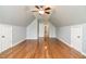 Large bonus room with vaulted ceiling, hardwood floors, and two closets at 236 Summer Place Ct, Clayton, NC 27527