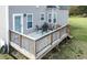 A wooden deck furnished with a metal table and chairs, perfect for outdoor dining and relaxation at 236 Summer Place Ct, Clayton, NC 27527