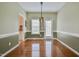 Elegant dining room with hardwood floors, wainscoting, and a modern light fixture at 236 Summer Place Ct, Clayton, NC 27527