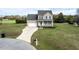 Charming two-story home with a well-maintained lawn, a two-car garage and a cozy front porch at 236 Summer Place Ct, Clayton, NC 27527