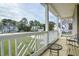 Charming front porch with decorative railing and comfortable seating, enhancing curb appeal at 236 Summer Place Ct, Clayton, NC 27527