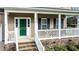 Inviting front porch with white railings, brick steps, and a vibrant green front door at 236 Summer Place Ct, Clayton, NC 27527