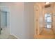 Upstairs hallway with beige carpeting and a doorway to a bonus room at 236 Summer Place Ct, Clayton, NC 27527