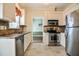 Well-equipped kitchen featuring stainless steel appliances, white cabinets, and tile flooring at 236 Summer Place Ct, Clayton, NC 27527