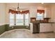 Bright kitchen with stainless steel dishwasher, white cabinets and a bay window eat-in area at 236 Summer Place Ct, Clayton, NC 27527