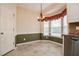 Bright kitchen with stainless steel dishwasher, white cabinets and a bay window eat-in area at 236 Summer Place Ct, Clayton, NC 27527