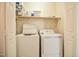 Functional laundry room with a washer, dryer, and shelving for storage at 236 Summer Place Ct, Clayton, NC 27527