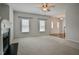 Bright living room with a decorative fireplace, carpet, and windows offering natural light at 236 Summer Place Ct, Clayton, NC 27527