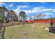 Large fenced backyard with mature trees and lush green grass at 24 High Standard Ln, Angier, NC 27501