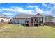 View of the home's backyard with a screened in porch and wooden fence at 24 High Standard Ln, Angier, NC 27501