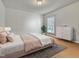 Serene bedroom with a bed, dresser, and large window creating a relaxing atmosphere at 24 High Standard Ln, Angier, NC 27501