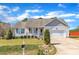 Charming single-story home with a well-manicured lawn, attached garage, and inviting front porch at 24 High Standard Ln, Angier, NC 27501