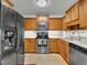Eat-in kitchen with stainless steel appliances, ample cabinetry and light countertops at 24 High Standard Ln, Angier, NC 27501