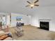 Inviting living room with high ceilings, ceiling fan, a fireplace and large windows at 24 High Standard Ln, Angier, NC 27501