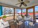 Comfortable screened porch with wood flooring, ceiling fan and outdoor seating at 24 High Standard Ln, Angier, NC 27501