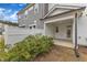 Cozy outdoor covered patio, white fence, and manicured shrubs creating a private backyard retreat at 242 Luftee Ln, Holly Springs, NC 27540