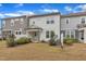An exterior of a home featuring a well-maintained backyard and landscaping at 242 Luftee Ln, Holly Springs, NC 27540