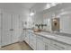 Bathroom featuring double sinks, granite counters, tile floors, and an enclosed shower at 242 Luftee Ln, Holly Springs, NC 27540