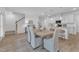 Dining room with modern light fixture and is adjacent to the kitchen and living spaces at 242 Luftee Ln, Holly Springs, NC 27540