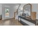 Welcoming entryway with a console table, mirror, and natural light streaming through the front door at 242 Luftee Ln, Holly Springs, NC 27540