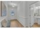 Bright entryway with hardwood floors, bench seating, and view of a half bathroom on the right at 242 Luftee Ln, Holly Springs, NC 27540
