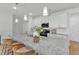 Beautiful kitchen with granite countertops, pendant lighting, and a center island perfect for entertaining at 242 Luftee Ln, Holly Springs, NC 27540