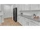 Kitchen area featuring stainless steel appliances, granite countertops, white cabinets and modern backsplash at 242 Luftee Ln, Holly Springs, NC 27540