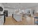 Open-concept gourmet kitchen features an island, stainless appliances, and seamless integration with living spaces at 242 Luftee Ln, Holly Springs, NC 27540