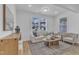 Cozy living room with comfortable seating, natural light, and stylish decor at 242 Luftee Ln, Holly Springs, NC 27540