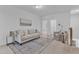 Upstairs sitting area with comfortable seating, carpet, and natural light at 242 Luftee Ln, Holly Springs, NC 27540