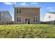 Home's back exterior features a patio and a grassy lawn, ideal for outdoor activities and relaxation at 250 Hawksbill Dr, Franklinton, NC 27525