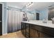 Bathroom features a double vanity with dark wood cabinets and a shower with a curtain at 250 Hawksbill Dr, Franklinton, NC 27525