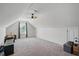 Spacious bonus room with neutral carpet, a ceiling fan, white walls, a window, and a sloped ceiling at 250 Hawksbill Dr, Franklinton, NC 27525