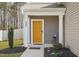 A closer view of the home's entryway with a bright yellow front door at 250 Hawksbill Dr, Franklinton, NC 27525