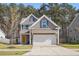 Charming two-story home with a two-car garage and a yellow front door at 250 Hawksbill Dr, Franklinton, NC 27525