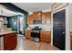 A well-equipped kitchen boasts stainless steel appliances, ample wooden cabinetry, granite countertops, and a pantry door at 250 Hawksbill Dr, Franklinton, NC 27525