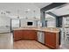 The eat-in kitchen features stainless steel appliances, wooden cabinets, and granite countertops and overlooks the living room at 250 Hawksbill Dr, Franklinton, NC 27525