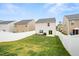 This backyard has a white fence and a nice patch of grass at 2512 Lily Dr, Haw River, NC 27258