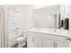 Bright bathroom featuring double sinks, a large mirror, and a shower-tub combo for a functional design at 2512 Lily Dr, Haw River, NC 27258