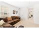 Inviting bonus room featuring a comfortable sectional sofa and plenty of natural light from the window at 2512 Lily Dr, Haw River, NC 27258