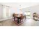Bright dining room with wood table, stylish rug, and sliding glass doors to the outdoor space at 2512 Lily Dr, Haw River, NC 27258